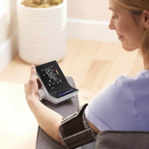 Kona mælir blóðþrýsting með Braun blóðþrýstingsmæli heima